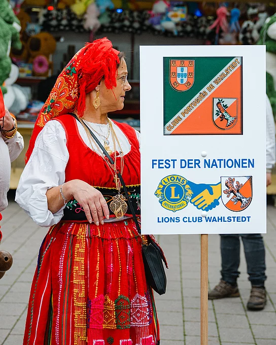 Frau in potugiesischer Tracht mit Schild Fest der Nationen